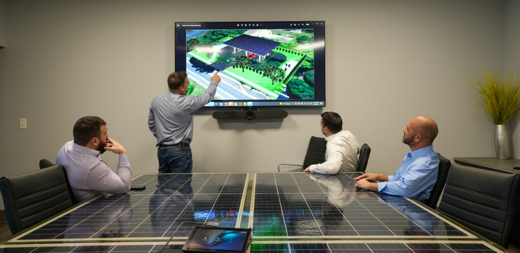 Koulomb's leadeship team meeting in front of a screen