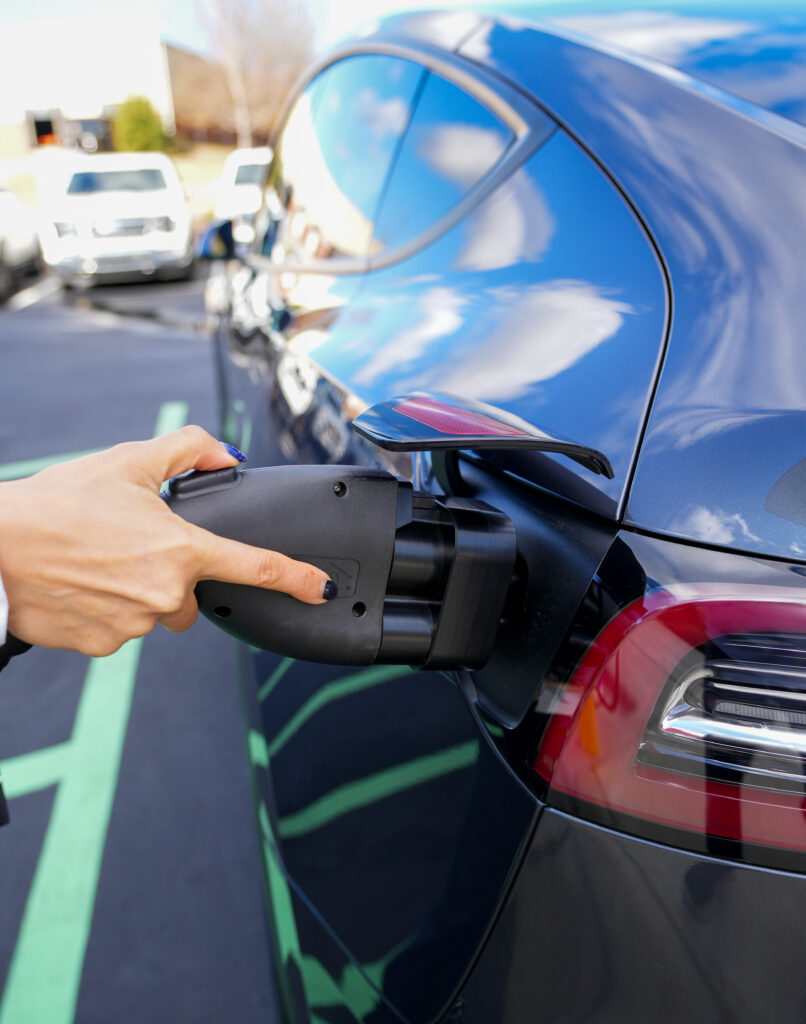 a person charging their EV at a Koulomb charging station